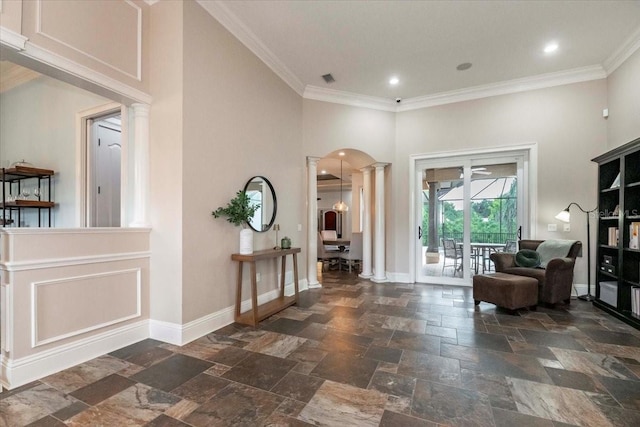 6357 Ashley Dr, Lakeland, FL 33813 - entrance foyer featuring ornate columns, stone tile flooring, ornamental molding, a towering ceiling, and baseboards
