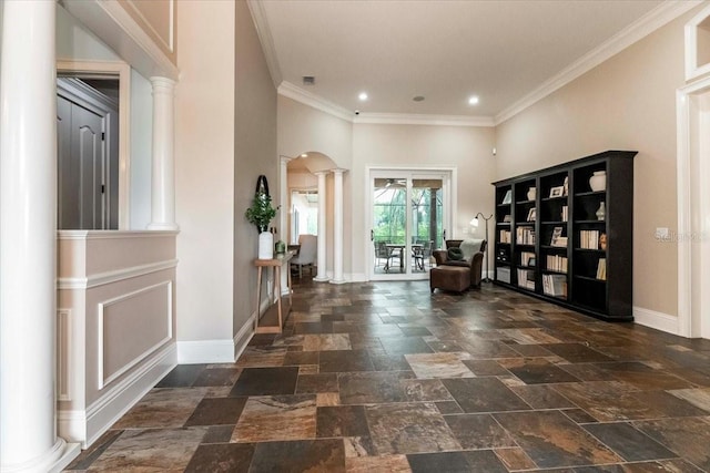 6357 Ashley Dr, Lakeland, FL 33813 - entryway with ornate columns, baseboards, stone tile flooring, ornamental molding, and arched walkways