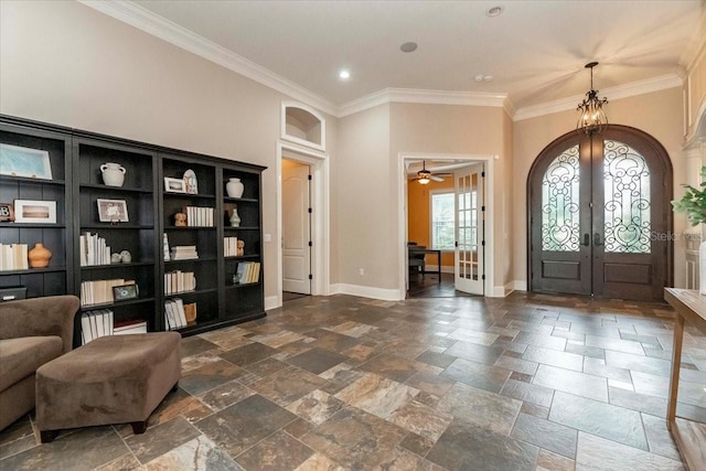 6357 Ashley Dr, Lakeland, FL 33813 - foyer entrance featuring french doors, stone tile floors, crown molding, baseboards, and recessed lighting