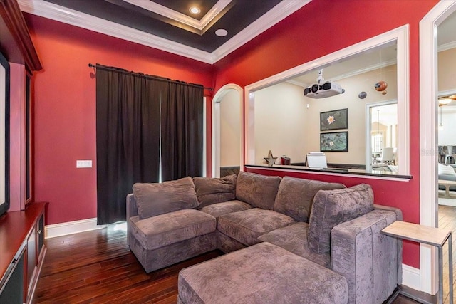 6357 Ashley Dr, Lakeland, FL 33813 - home theater room with crown molding, dark wood-style flooring, arched walkways, and baseboards