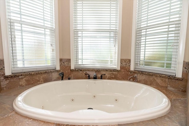 6357 Ashley Dr, Lakeland, FL 33813 - bathroom with a tub with jets and healthy amount of natural light