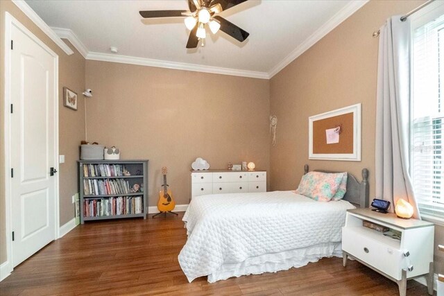 6357 Ashley Dr, Lakeland, FL 33813 - bedroom featuring multiple windows, wood finished floors, crown molding, and baseboards