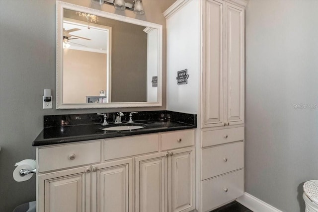 6357 Ashley Dr, Lakeland, FL 33813 - half bath featuring vanity, baseboards, crown molding, toilet, and ceiling fan