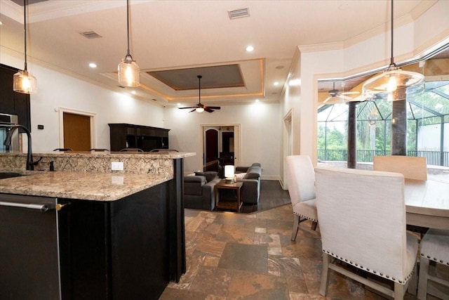 6357 Ashley Dr, Lakeland, FL 33813 - kitchen featuring ornamental molding, ceiling fan, stainless steel dishwasher, dark cabinetry, and a raised ceiling