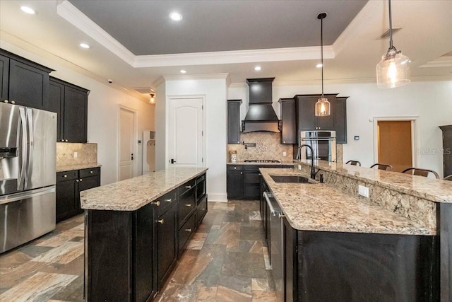 6357 Ashley Dr, Lakeland, FL 33813 - kitchen with stainless steel appliances, a large island, a sink, dark cabinetry, and crown molding