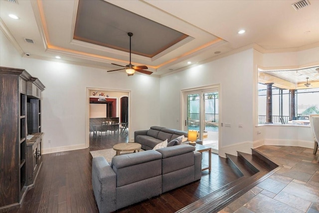 6357 Ashley Dr, Lakeland, FL 33813 - living area featuring ornamental molding, a raised ceiling, healthy amount of natural light, baseboards, and recessed lighting