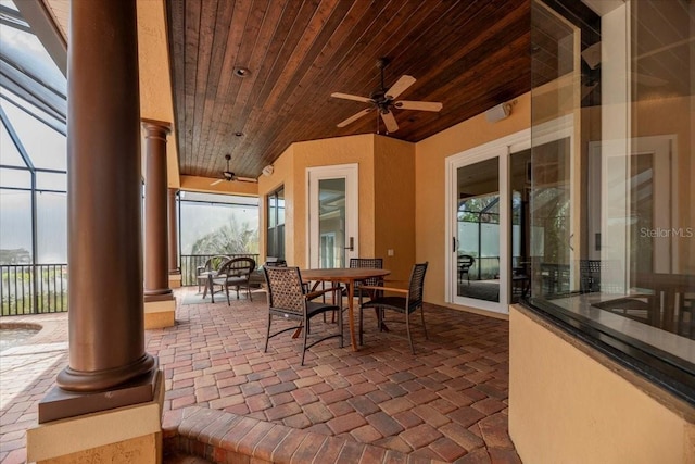6357 Ashley Dr, Lakeland, FL 33813 - view of patio with a ceiling fan, outdoor dining space, and glass enclosure