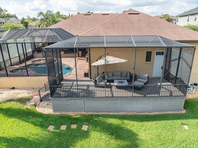 6357 Ashley Dr, Lakeland, FL 33813 - back of property with a patio, outdoor lounge area, and a lawn