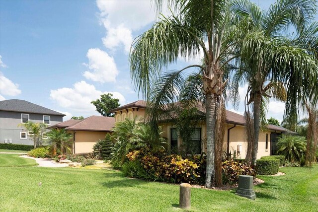 6357 Ashley Dr, Lakeland, FL 33813 - view of front of house featuring stucco siding and a front lawn