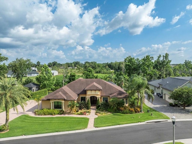 6357 Ashley Dr, Lakeland, FL 33813 - view of front of house with a front yard, stucco siding, and driveway