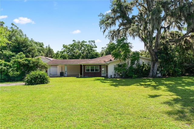 5425 Lewellyn Rd, Lakeland, FL 33810 - ranch-style home featuring a garage, a front lawn, and central air condition unit