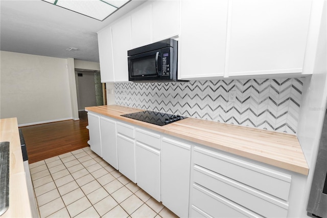 5425 Lewellyn Rd, Lakeland, FL 33810 - kitchen featuring wood counters, black appliances, light tile patterned floors, tasteful backsplash, and white cabinetry
