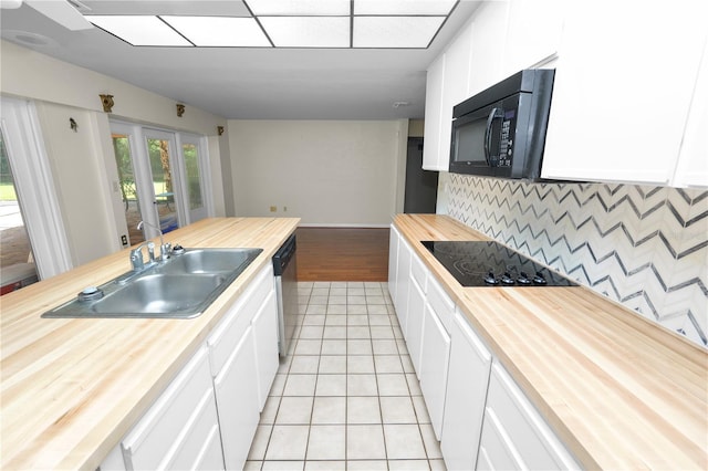5425 Lewellyn Rd, Lakeland, FL 33810 - kitchen featuring wooden counters, black appliances, a sink, light tile patterned floors, and decorative backsplash