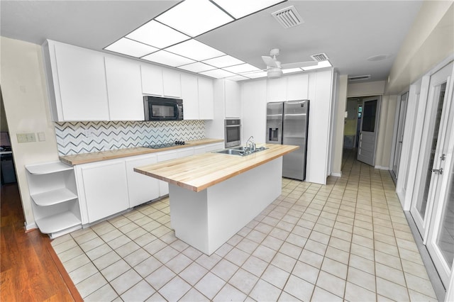 5425 Lewellyn Rd, Lakeland, FL 33810 - kitchen featuring wood counters, black appliances, a sink, open shelves, and decorative backsplash