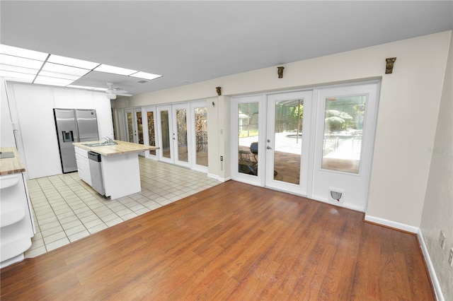 5425 Lewellyn Rd, Lakeland, FL 33810 - kitchen featuring french doors, butcher block counters, appliances with stainless steel finishes, and a sink