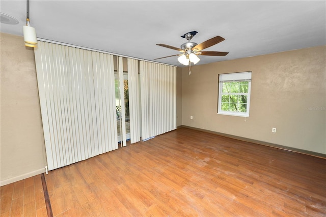 5425 Lewellyn Rd, Lakeland, FL 33810 - empty room with wood finished floors, ceiling fan, and baseboards