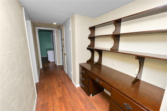 5425 Lewellyn Rd, Lakeland, FL 33810 - corridor featuring wood finished floors, an office area, a textured wall, and baseboards