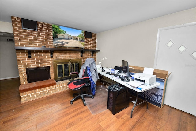 5425 Lewellyn Rd, Lakeland, FL 33810 - office featuring a brick fireplace and wood finished floors