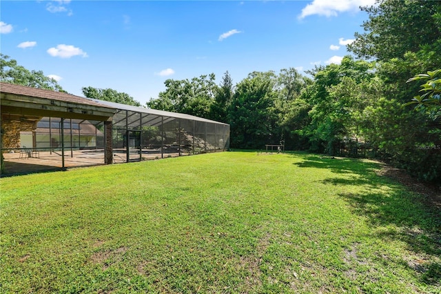5425 Lewellyn Rd, Lakeland, FL 33810 - view of green lawn with glass enclosure and a patio