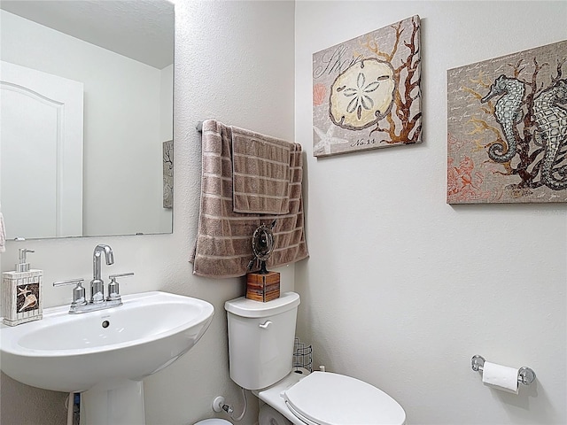 half bathroom with a sink and toilet