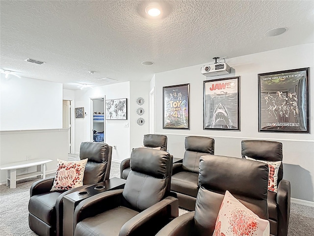 home theater featuring carpet floors, a textured ceiling, and baseboards