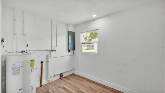 6543 Tula Ln, Lakeland, FL 33809 - laundry room with water heater, electric panel, light wood-type flooring, baseboards, and recessed lighting