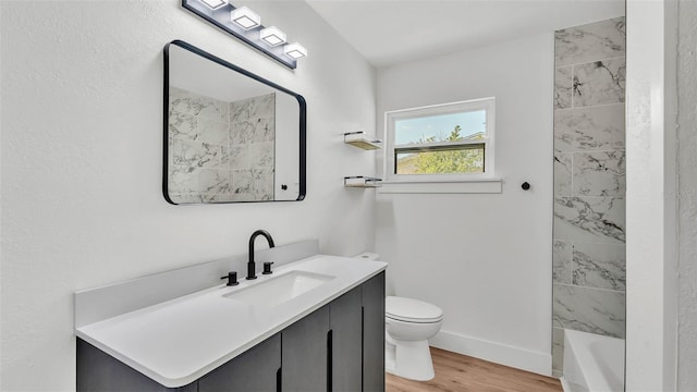6543 Tula Ln, Lakeland, FL 33809 - bathroom featuring wood finished floors, toilet, baseboards, and vanity