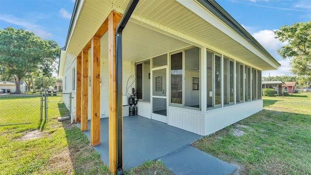 6543 Tula Ln, Lakeland, FL 33809 - view of side of property featuring a sunroom and a gate