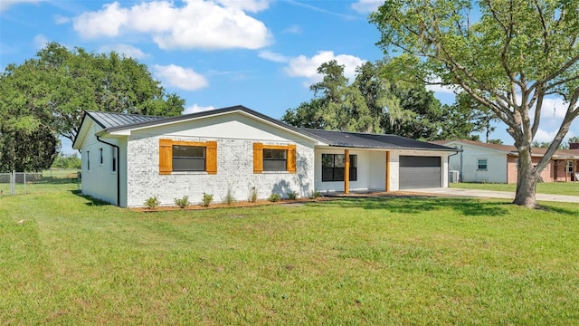 6543 Tula Ln, Lakeland, FL 33809 - ranch-style house with a garage, driveway, metal roof, and a standing seam roof