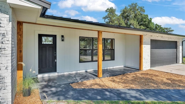 6543 Tula Ln, Lakeland, FL 33809 - entrance to property with a garage, concrete driveway, and covered porch