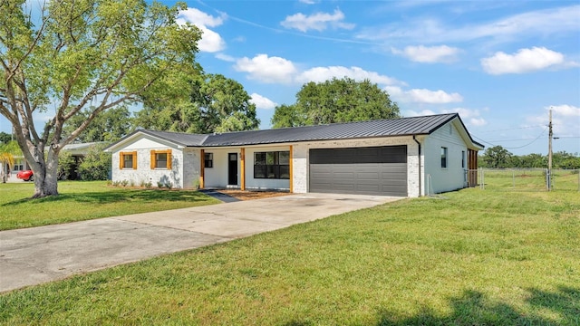 6543 Tula Ln, Lakeland, FL 33809 - ranch-style house with a garage, concrete driveway, metal roof, a standing seam roof, and brick siding
