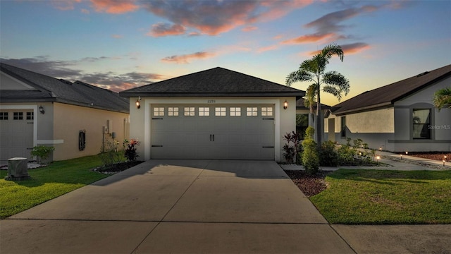 2293 Caspian Dr, Lakeland, FL 33805 - single story home featuring stucco siding, concrete driveway, a lawn, and an attached garage