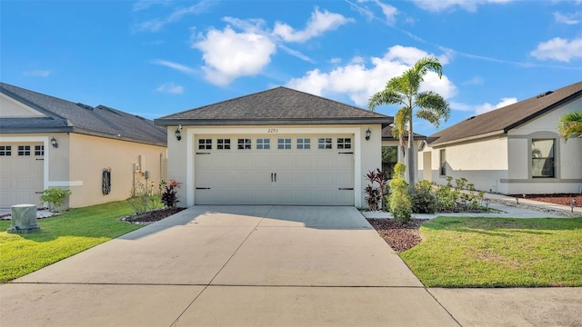 2293 Caspian Dr, Lakeland, FL 33805 - view of front of property with a front yard, stucco siding, concrete driveway, and an attached garage