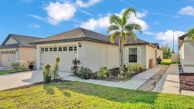 2293 Caspian Dr, Lakeland, FL 33805 - view of front of house featuring a garage, stucco siding, concrete driveway, and a front yard
