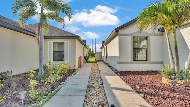 2293 Caspian Dr, Lakeland, FL 33805 - view of property exterior with stucco siding and roof with shingles
