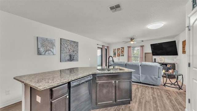 2293 Caspian Dr, Lakeland, FL 33805 - kitchen with dishwasher, a sink, light wood-style flooring, a center island with sink, and dark brown cabinets