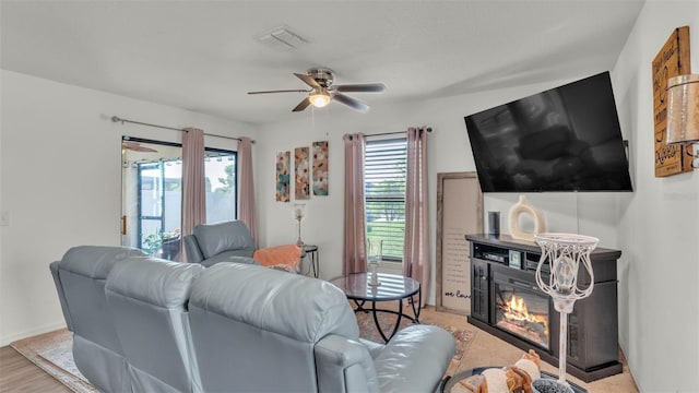 2293 Caspian Dr, Lakeland, FL 33805 - living area with ceiling fan and a glass covered fireplace