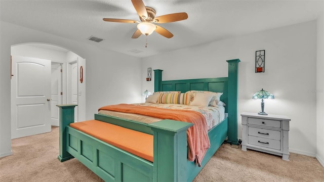 2293 Caspian Dr, Lakeland, FL 33805 - bedroom with light colored carpet, arched walkways, a ceiling fan, and baseboards
