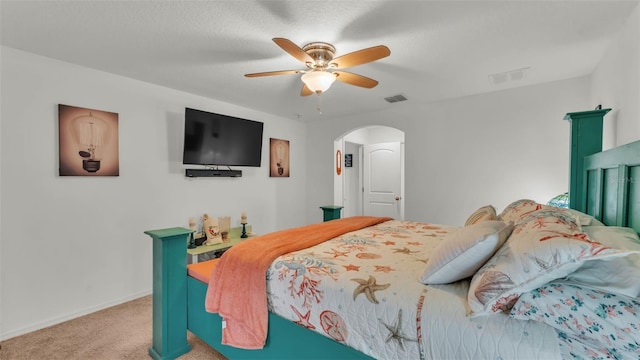 2293 Caspian Dr, Lakeland, FL 33805 - bedroom with arched walkways, light colored carpet, baseboards, and a ceiling fan