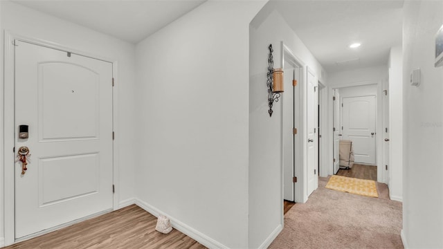 2293 Caspian Dr, Lakeland, FL 33805 - foyer with baseboards, light wood-style floors, and recessed lighting