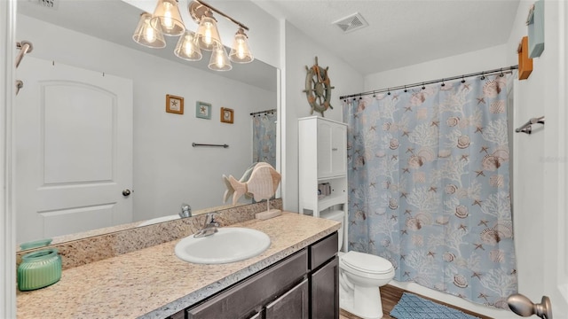 2293 Caspian Dr, Lakeland, FL 33805 - full bathroom featuring a chandelier, toilet, and vanity