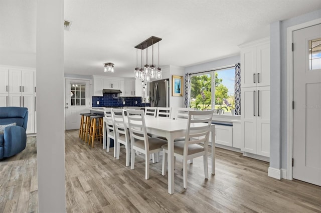 3810 Harrelson Rd, Lakeland, FL 33810 - dining area featuring light wood-type flooring and a chandelier