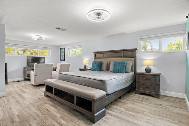 3810 Harrelson Rd, Lakeland, FL 33810 - bedroom featuring baseboards, light wood-type flooring, an office area, and multiple windows