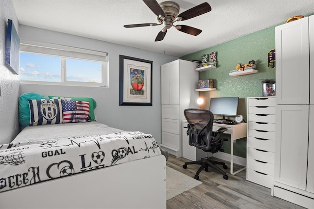 3810 Harrelson Rd, Lakeland, FL 33810 - bedroom with wood finished floors, a textured wall, a textured ceiling, ceiling fan, and an office area