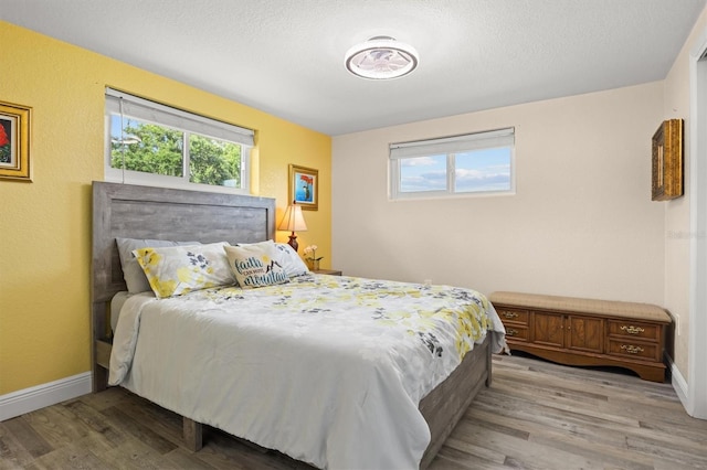 3810 Harrelson Rd, Lakeland, FL 33810 - bedroom with light wood finished floors, baseboards, and a textured ceiling