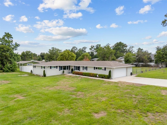3810 Harrelson Rd, Lakeland, FL 33810 - ranch-style home featuring concrete driveway, a garage, stucco siding, and view of wooded area