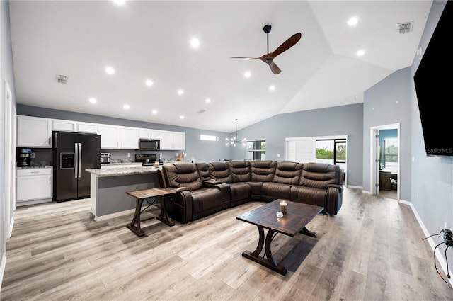 3883 Sandhill Crane Dr, Lakeland, FL 33811 - living room with ceiling fan, high vaulted ceiling, recessed lighting, a chandelier, and light wood-style flooring