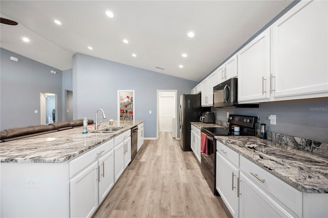 3883 Sandhill Crane Dr, Lakeland, FL 33811 - kitchen featuring appliances with stainless steel finishes, a sink, white cabinetry, a kitchen island with sink, and light wood-type flooring