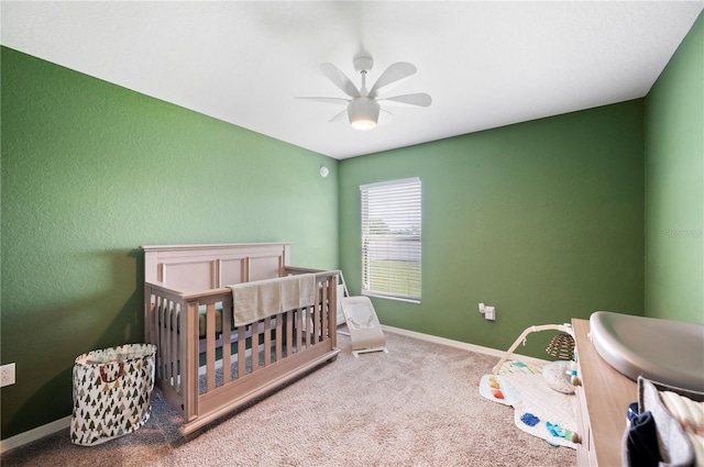 3883 Sandhill Crane Dr, Lakeland, FL 33811 - bedroom featuring a crib, carpet flooring, ceiling fan, and baseboards