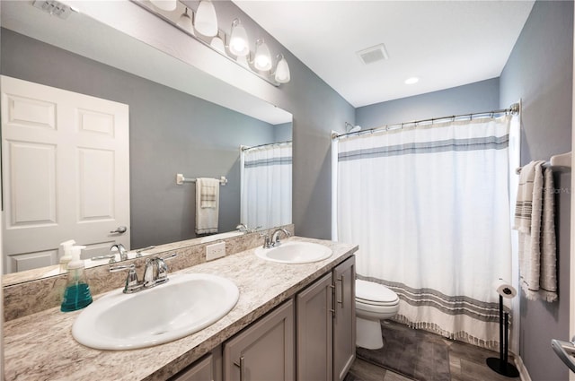 3883 Sandhill Crane Dr, Lakeland, FL 33811 - full bathroom with double vanity, toilet, wood finished floors, and curtained shower